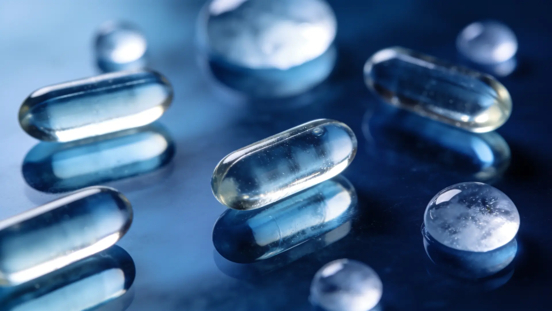 Translucent capsules on blue glass