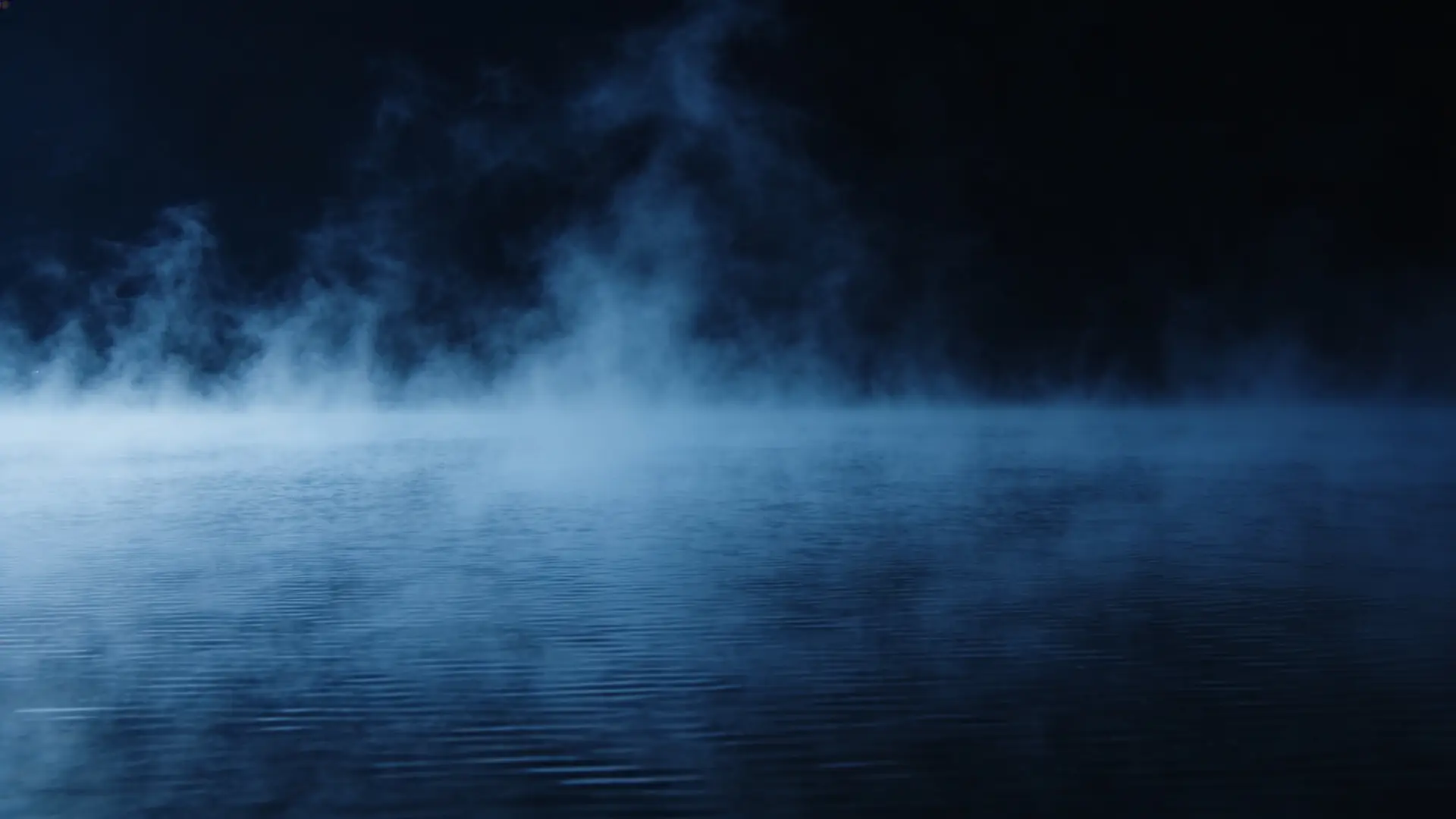 Steam rising over dark water